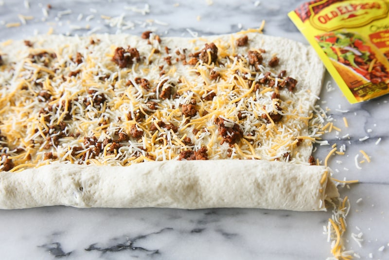 Taco Pizza Rolls - taco meat and cheese rolled up in pizza dough and topped with your favorite taco toppings. the-girl-who-ate-everything.com