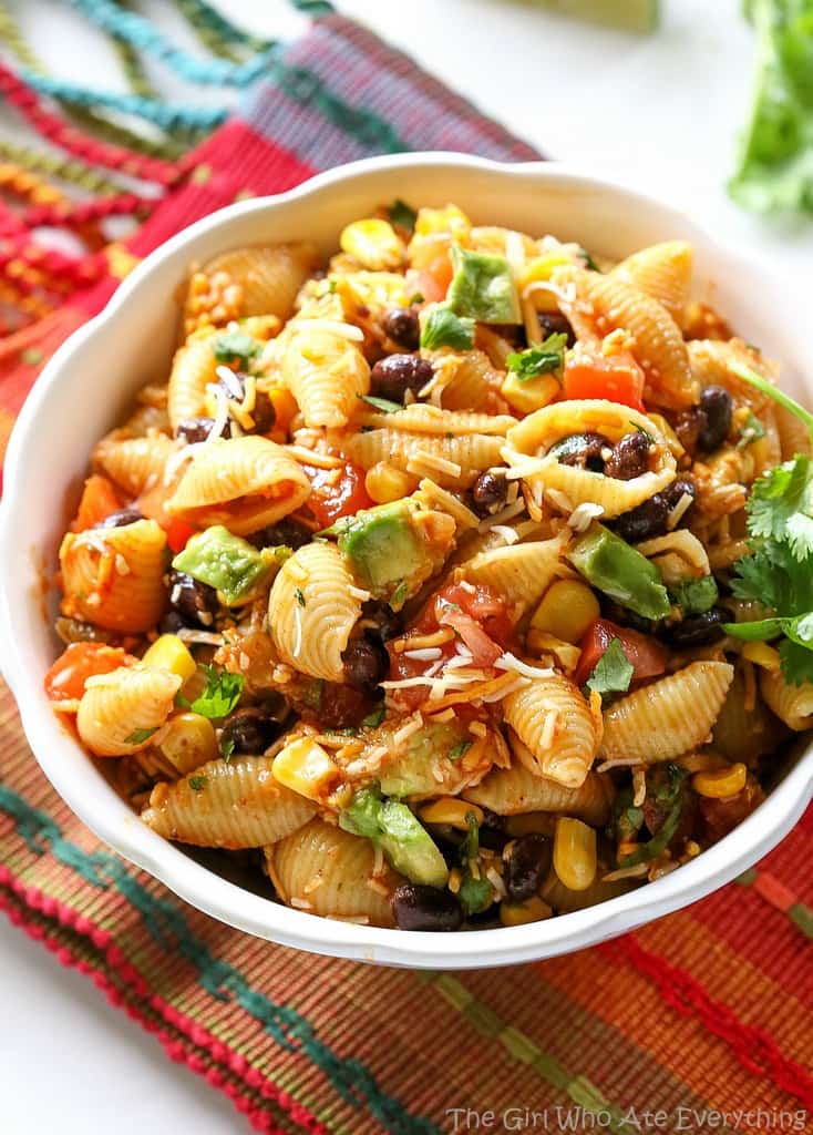 This Taco Pasta Salad is filled with black beans, corn, cilantro, avocados, and tomatoes. the-girl-who-ate-everything.com