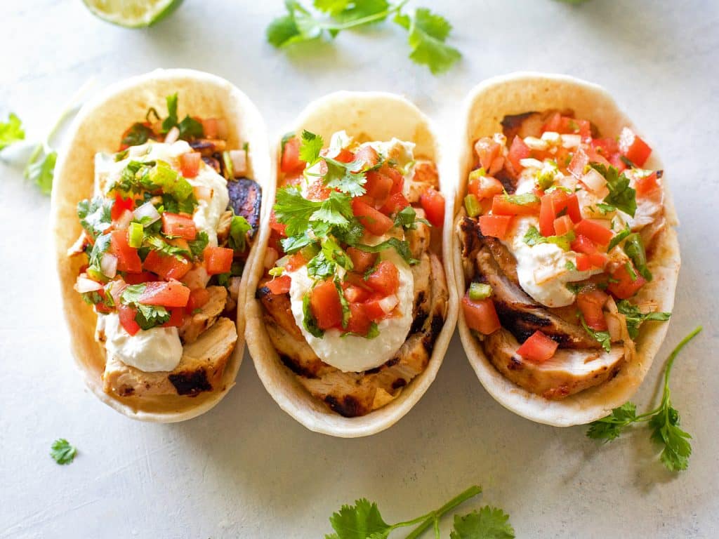 Grilled Chicken Tacos with Feta Cream - so much flavor in these that it's hard to eat just one! the-girl-who-ate-everything.com