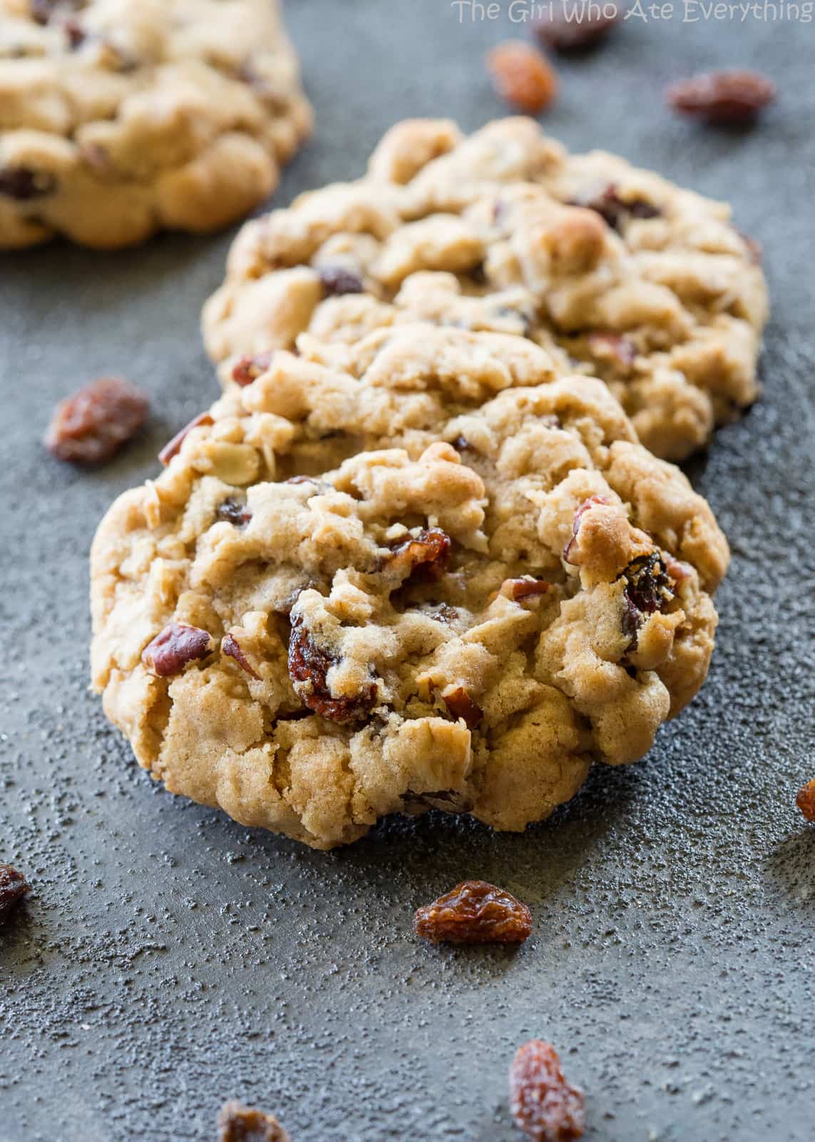 Chewy Oatmeal Raisin Cookie on a surface with raisins