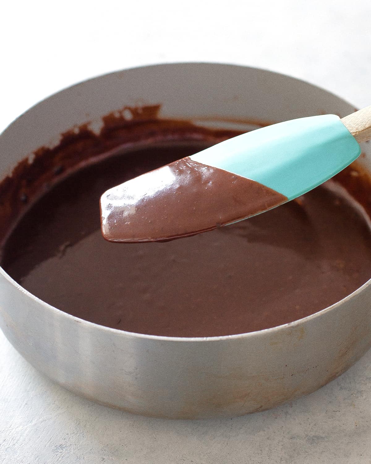 chocolate sauce on a blue spatula