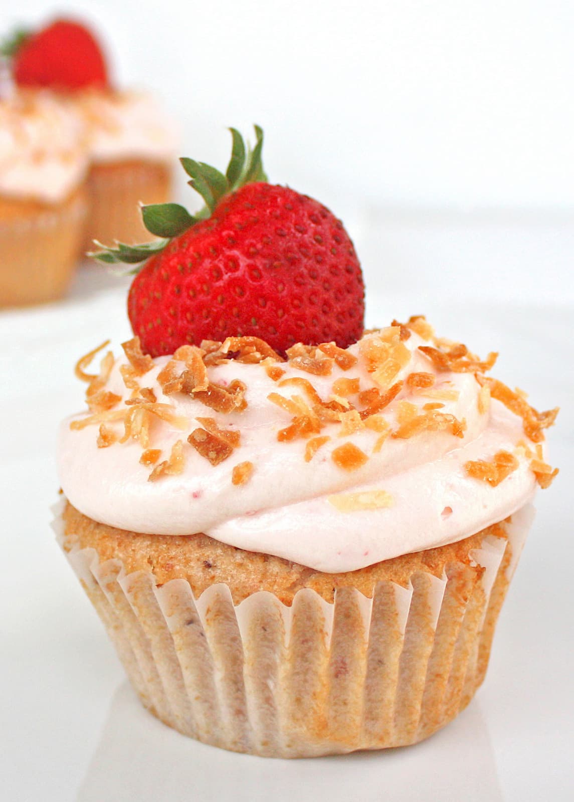 Strawberry Colada Cupcakes - Strawberry and coconut cupcakes topped with toasted coconut! the-girl-who-ate-everything.com