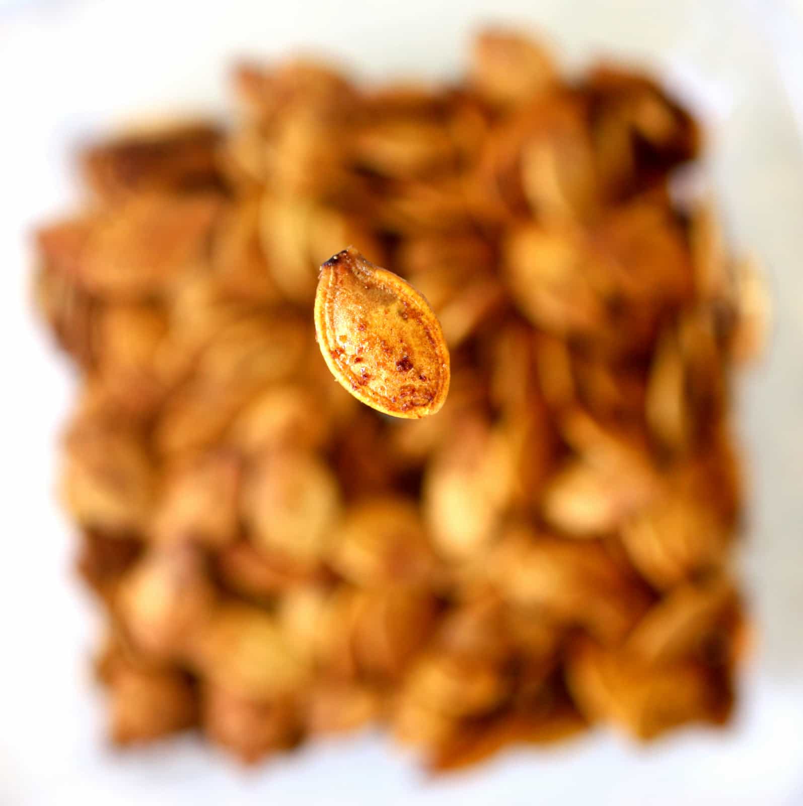 Roasted Pumpkin Seeds are easier than you think. If you've ever wanted to know how to roast pumpkin seeds, I'll teach you. This roasted pumpkin seeds recipe are crispy and full of seasoning! #pumpkin #seeds the-girl-who-ate-everything.com