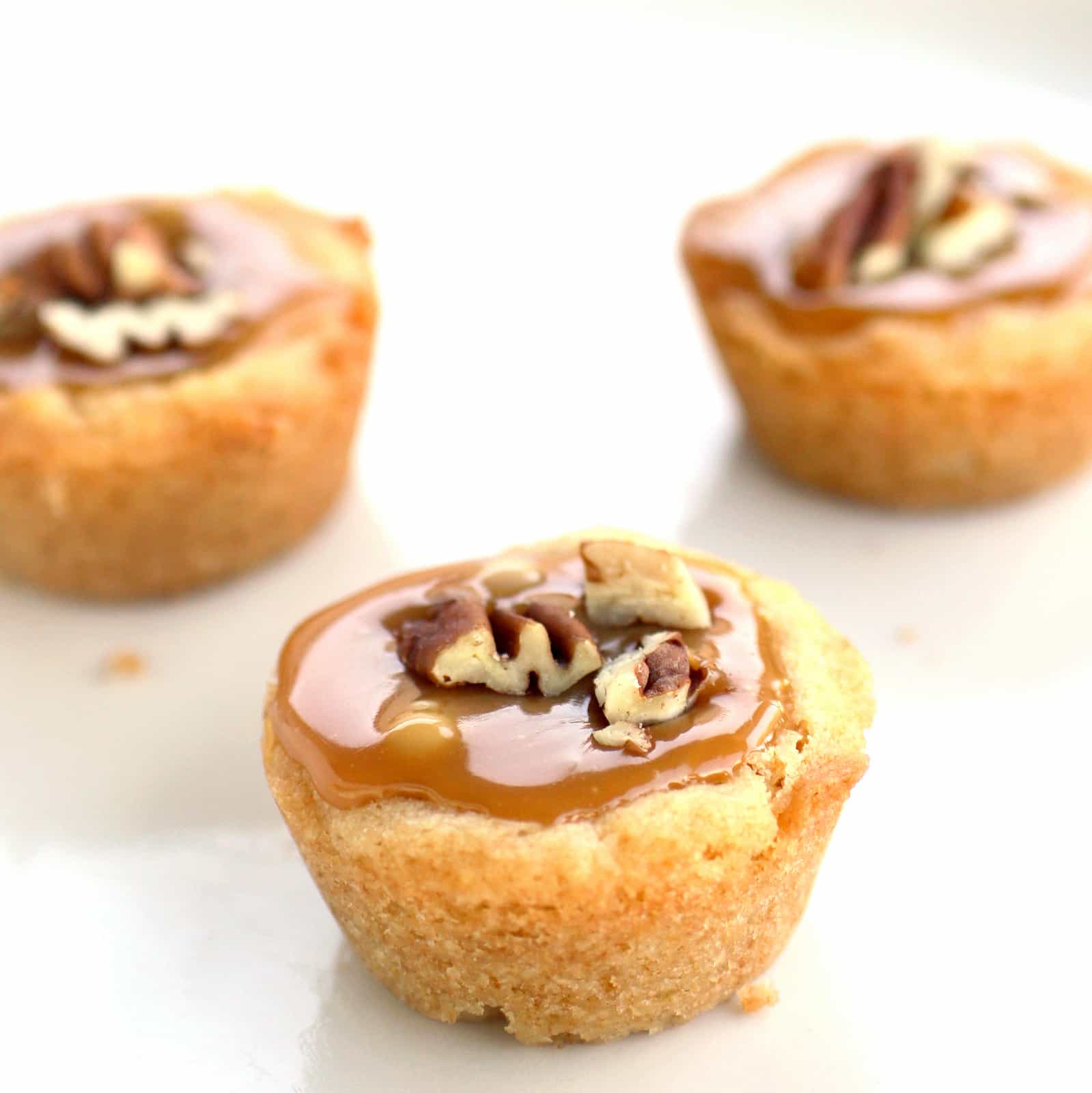 Turtle Tassies - Caramel, chocolate, and nuts in a sugar cookie cup. the-girl-who-ate-everything.com