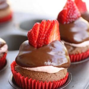 Strawberry Puffcakes - chocolate cupcakes topped with strawberry cream and dipped in chocolate. the-girl-who-ate-everything.com