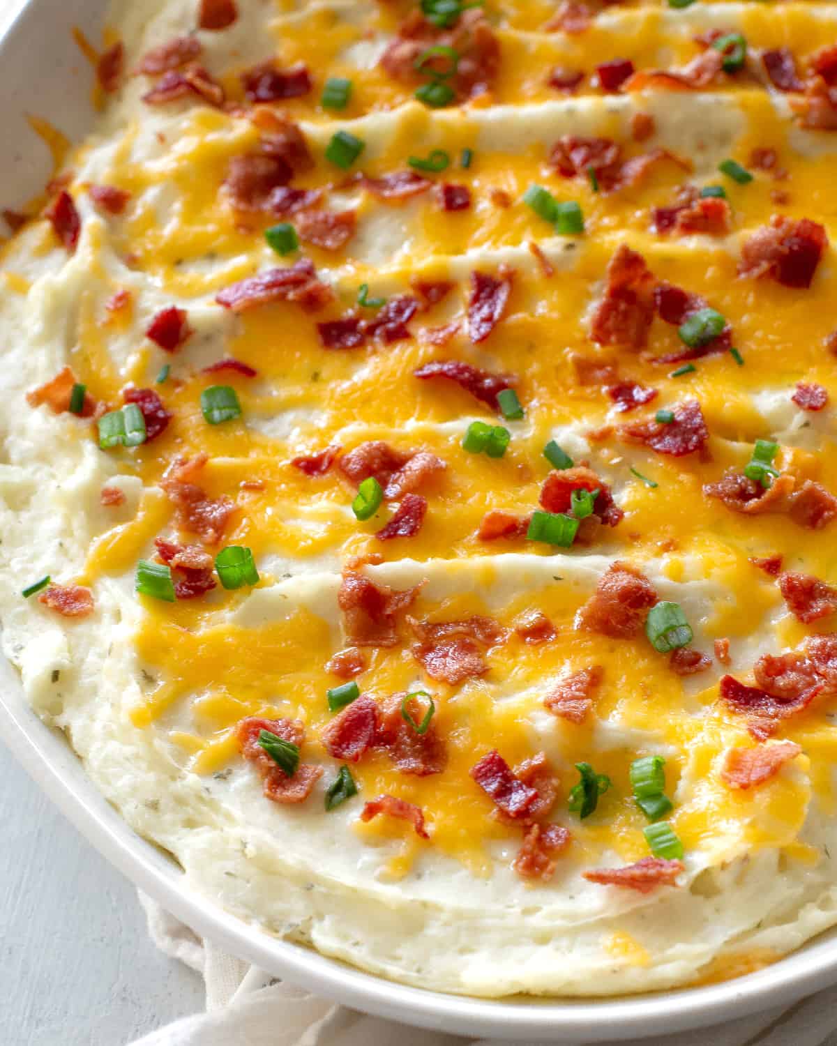 potatoes with cheese, bacon, and green onions