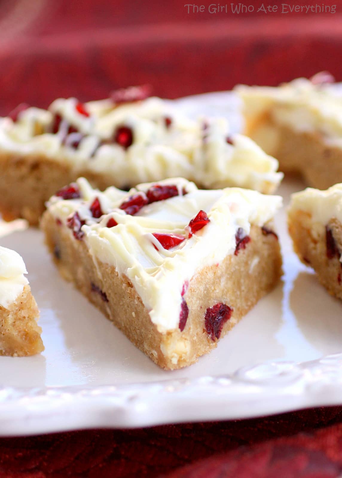 Cranberry Bliss Bars - a knockoff of the Starbuck's treat. A blondie dotted with white chocolate and cranberries with a slight hint of orange. the-girl-who-ate-everything.com 