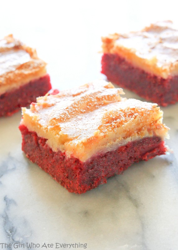 These Red Velvet Gooey Butter Bars are moist red velvet cake topped with a buttery cream cheese layer. Great for Halloween, Christmas, Valentine's Day, or the Fourth of July. the-girl-who-ate-everything.com