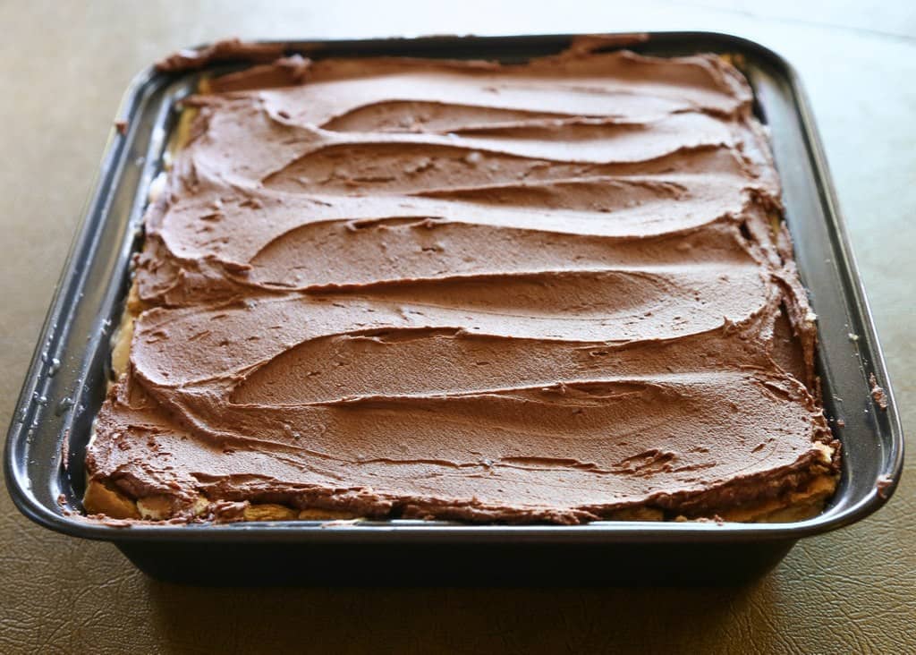Chunky Monkey Eclair Cake - An easy no-bake dessert with layers of graham crackers, peanut butter filling, and bananas. All topped with a sweet homemade chocolate frosting. the-girl-who-ate-everything.com