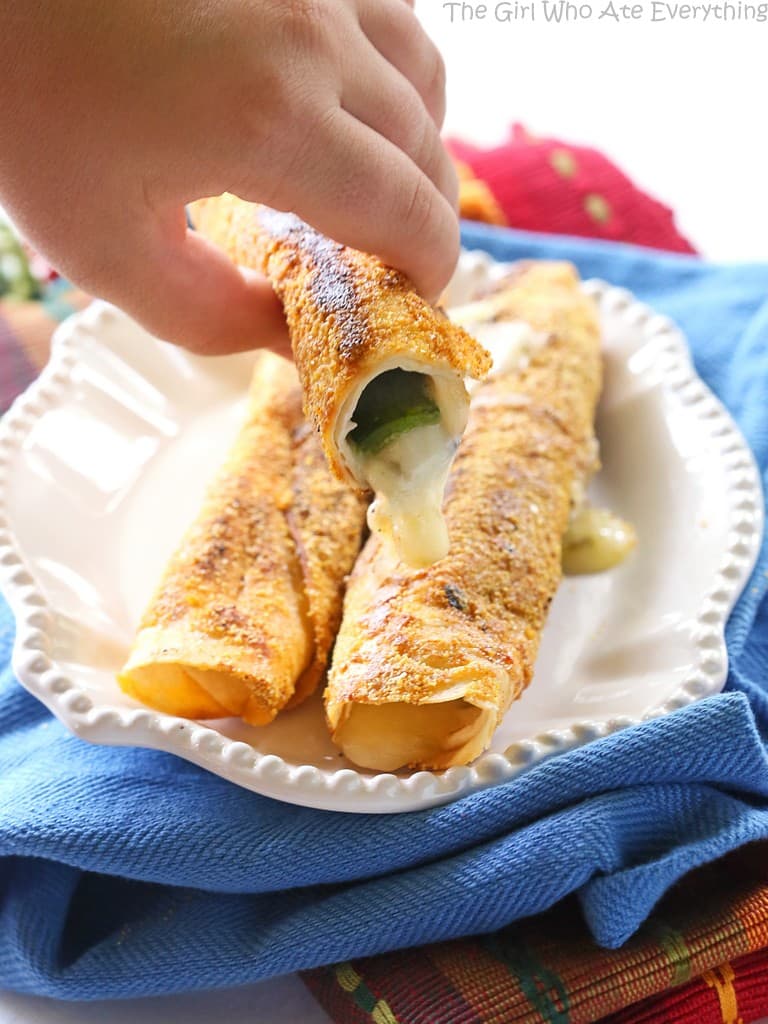 Chile Relleno Flautas - a poblano pepper and Monterey Jack cheese rolled up in a flour tortilla, sprinkled with seasoned cornmeal, and pan-fried until toasty. the-girl-who-ate-everything.com