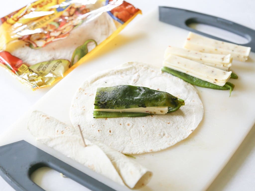 Chile Relleno Flautas - a poblano pepper and Monterey Jack cheese rolled up in a flour tortilla, sprinkled with seasoned cornmeal, and pan-fried until toasty. the-girl-who-ate-everything.com