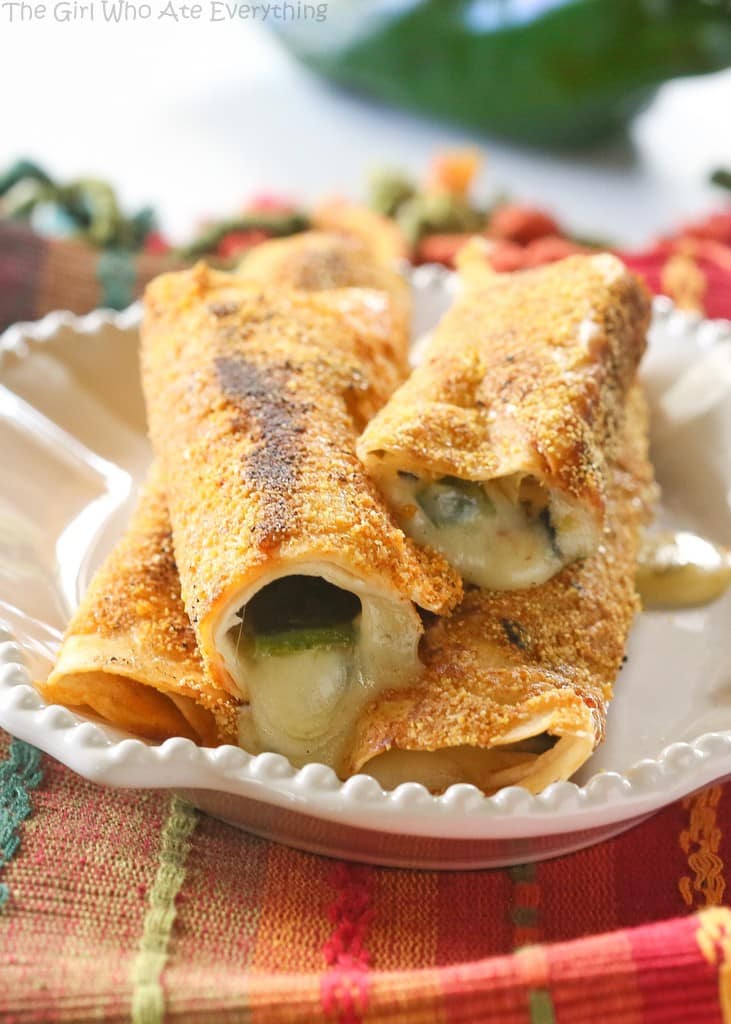 Chile Rellenos Flautas - a poblano pepper and Monterey Jack cheese rolled up in a flour tortilla, sprinkled with seasoned cornmeal, and pan-fried until toasty. the-girl-who-ate-everything.com