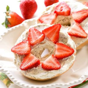 Strawberry Lemon Poppy Seed Bagel - a delicious and creamy almond poppy seed mixture is topped with sliced strawberries. the-girl-who-ate-everything.com