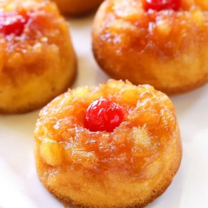 Pineapple Upside Down Cupcakes - a mini version of your favorite cake with butter, brown sugar, pineapple, and a cherry on top! the-girl-who-ate-everything.com