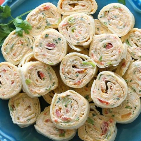 These Chicken Enchilada Roll Ups are a great appetizer for parties! Easy to make ahead and easy to serve. the-girl-who-ate-everything.com