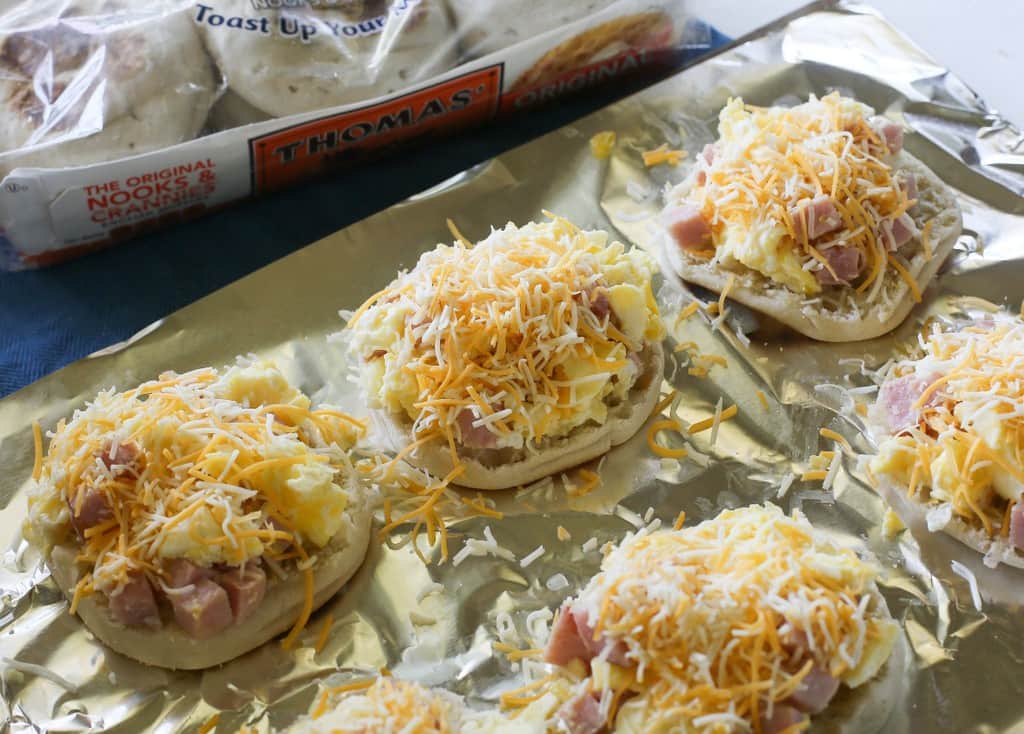 Breakfast Pizzas - toasty English muffins topped with scrambled eggs, ham, and melted cheese. the-girl-who-ate-everything.com