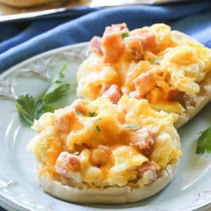 Breakfast Pizzas - toasty English muffins topped with scrambled eggs, ham, and melted cheese. the-girl-who-ate-everything.com