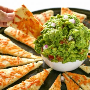 An Italian guacamole made with basil, garlic, avocado, red onions, and tomato. Instead of chips, super thin pizza crust strips are used. A knock-off from one of our favorite restaurant appetizers. the-girl-who-ate-everything.com