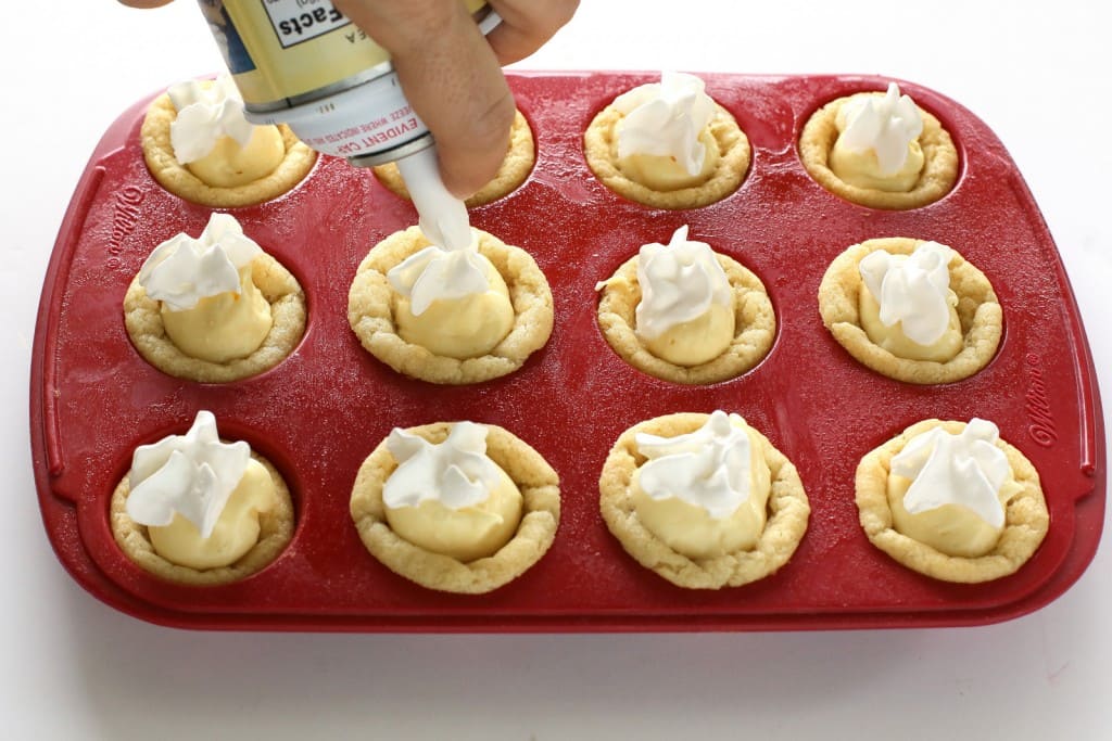 These Eggnog Cookie Cups are sugar cookie cups filled with a creamy eggnog filling. Super easy and festive for Christmas! the-girl-who-ate-everything.com