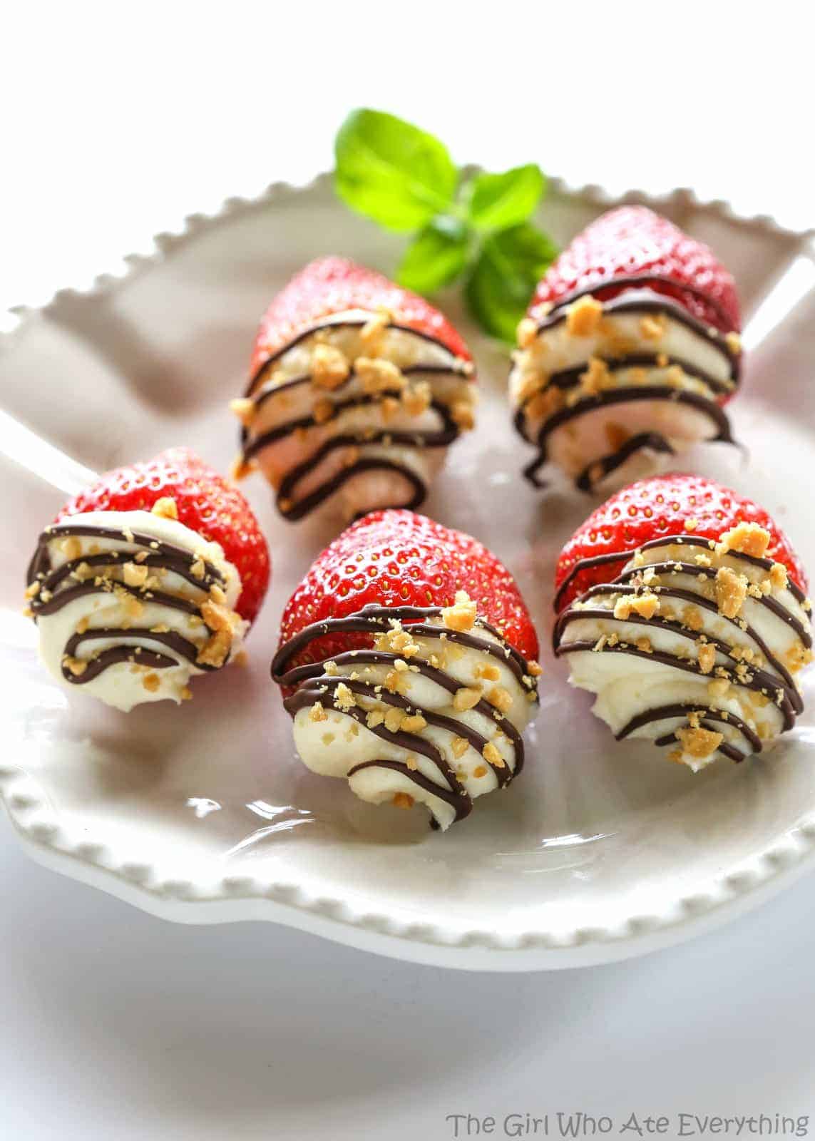 Mascarpone Stuffed Strawberrries. Sweet and silky mascarpone filled strawberries drizzled with chocolate and nuts. the-girl-who-ate-everything.com