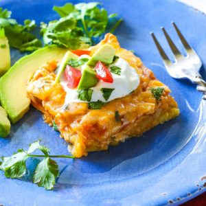 Chicken Tamale Casserole - a sweet cornbread crust topped with enchilada sauce and chicken. This is a crowd pleaser! the-girl-who-ate-everything.com