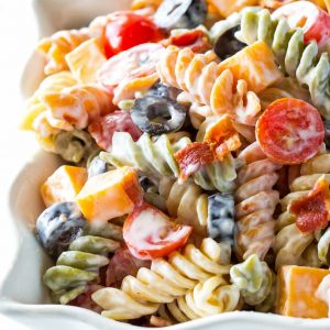 Bacon Ranch Pasta Salad - flavorful pasta salad with cheddar cheese, olives, tomatoes, and bacon. Covered in a creamy ranch sauce. the-girl-who-ate-everything.com