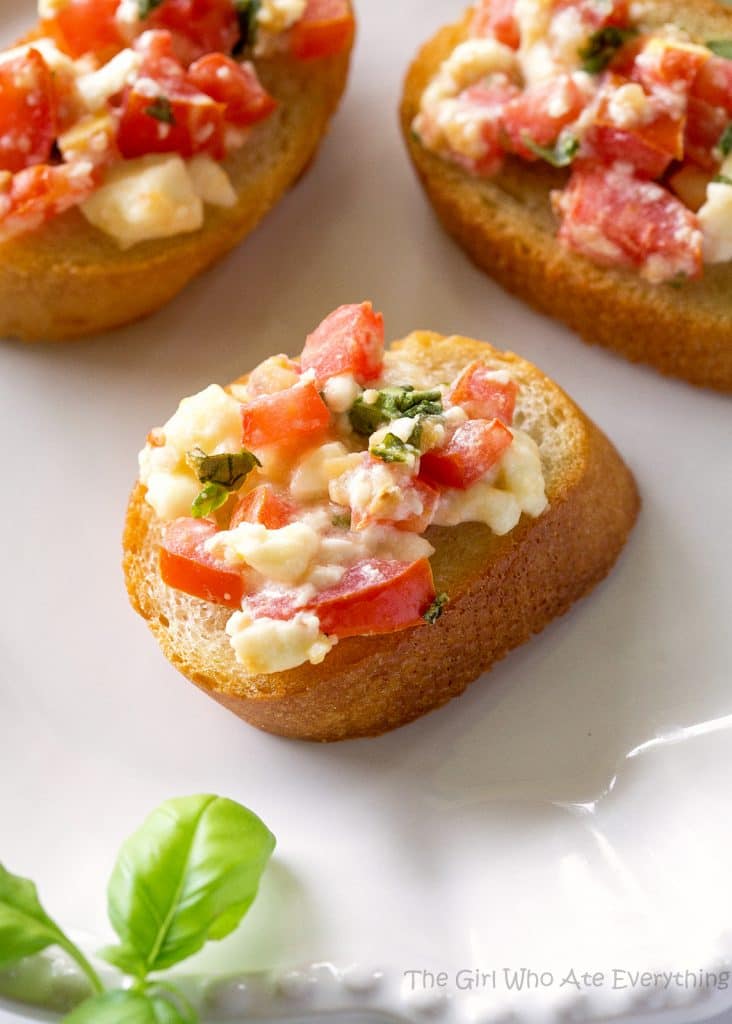 Tomato Feta Bruschetta - a flavor party in your mouth! An impressive appetizer that's so easy. the-girl-who-ate-everything.com