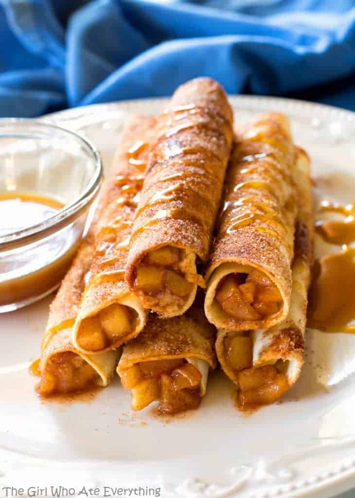 Creamy Caramel Apple Taquitos - filled with cinnamon apples, caramel, and cream cheese, rolled in cinnamon sugar and drizzled with caramel. the-girl-who-ate-everything.com