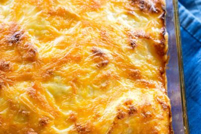 Scalloped Potatoes - a classic dish with potatoes, cheesy sauce, and baked until perfection! the-girl-who-ate-everything.com