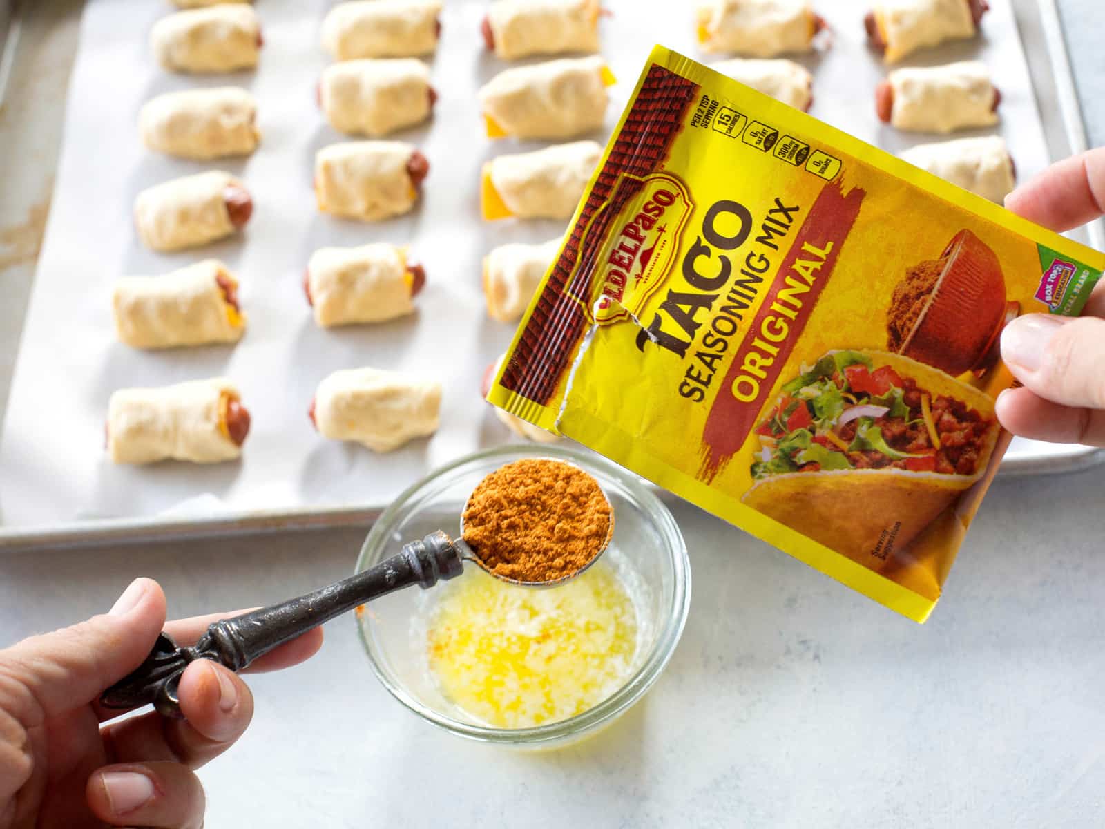 Taco Pigs in a Blanket - a Mexican twist on the classic appetizer. Make a toppings bar so everyone can top their own. the-girl-who-ate-everything.com