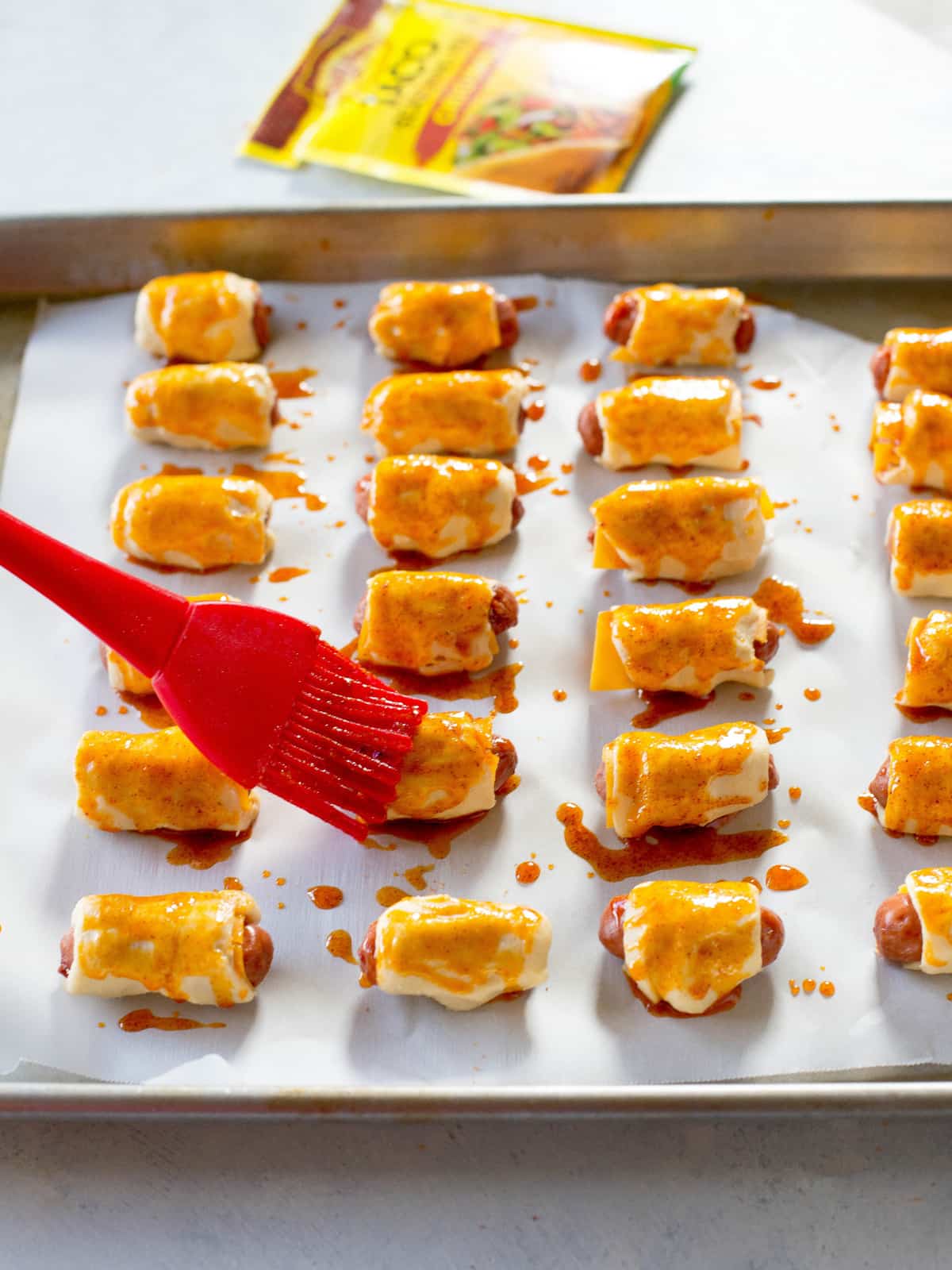 Taco Pigs in a Blanket - a Mexican twist on the classic appetizer. Make a toppings bar so everyone can top their own. the-girl-who-ate-everything.com
