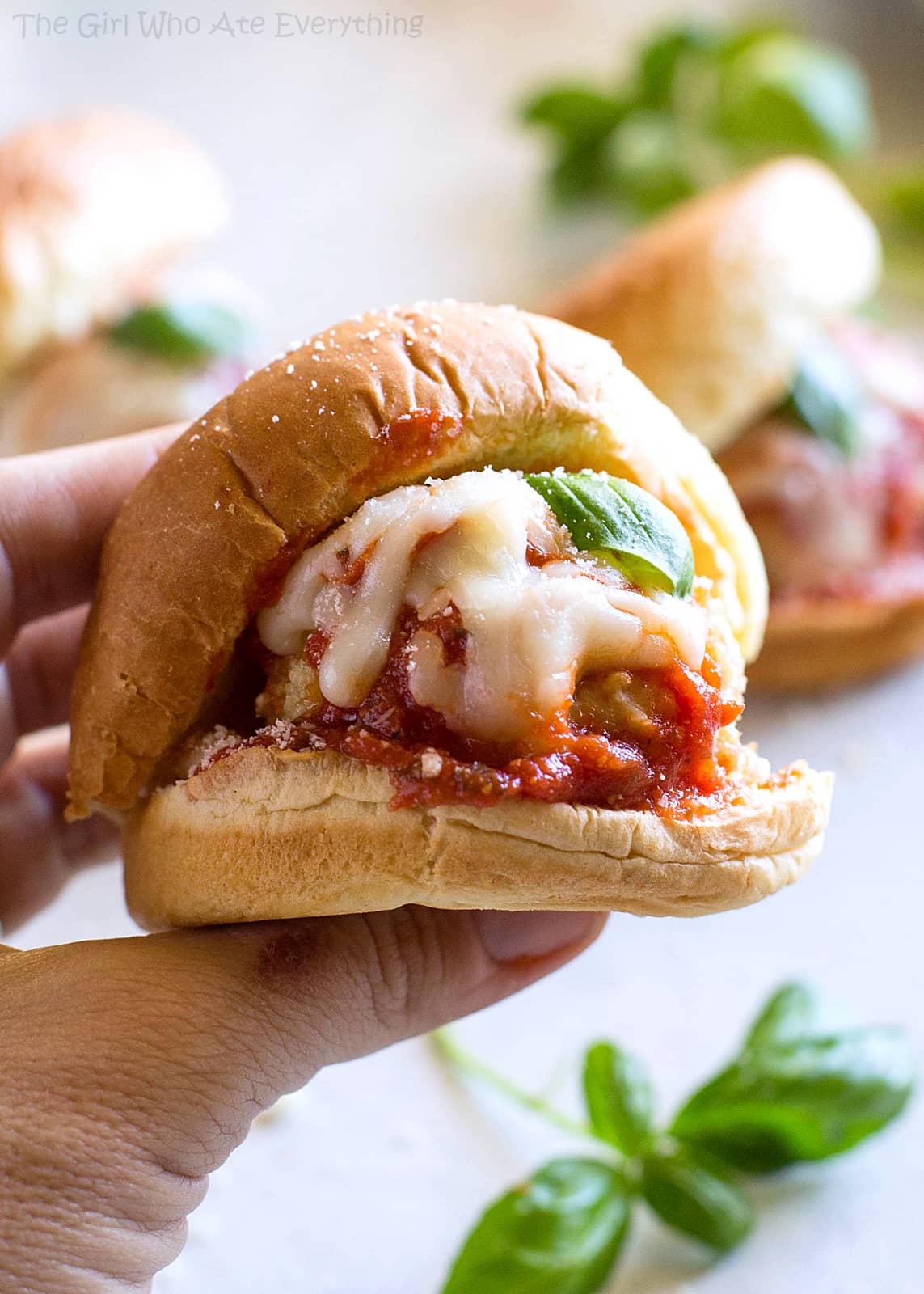 Chicken Parmesan Meatball Sliders - so easy and always a crowd pleaser. You can serve them as appetizers or dinner like I usually do! the-girl-who-ate-everything.com