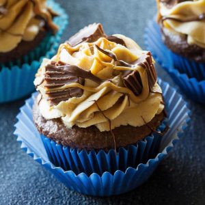 Reese's Peanut Butter Cupcakes - stuffed with Reese's Peanut Butter Cups and topped with a peanut butter frosting. the-girl-who-ate-everything.com
