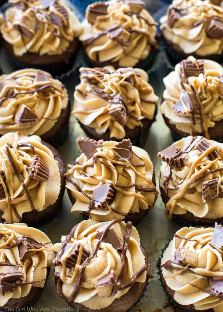Reese's Peanut Butter Cupcakes - stuffed with Reese's Peanut Butter Cups and topped with a peanut butter frosting. the-girl-who-ate-everything.com
