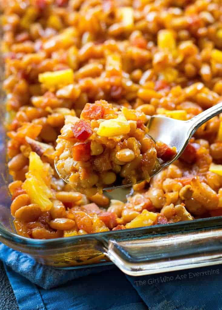 Hawaiian Baked Beans - sweet and salty with bits of ham throughout!. A great side for luaus or BBQs. the-girl-who-ate-everything.com