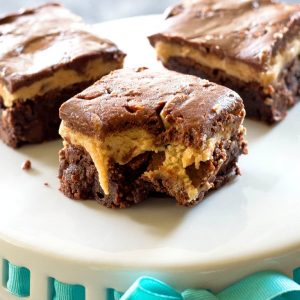 Turtle Buckeye Brownies - rich chocolate brownies, a peanut butter truffle layer and topped with a caramel chocolate pecan layer. The ultimate decadent dessert. the-girl-who-ate-everything.com