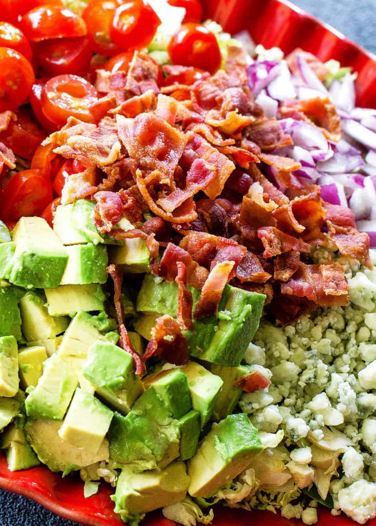 This Shaved Brussels Sprouts Salad is shaved Brussels sprouts with bacon, onion, tomato, avocado, and Gorgonzola cheese. the-girl-who-ate-everything.com