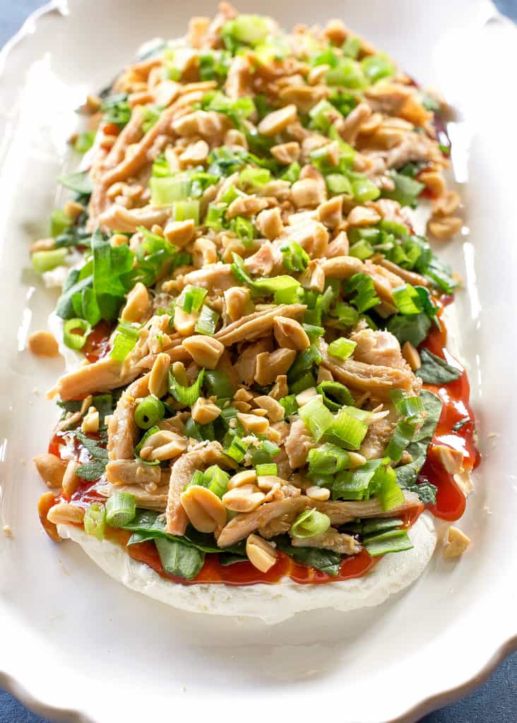 This Sesame Chicken Dip is fresh and full of Asian flavors. This appetizer has layers of cream cheese, sweet and sour sauce, chicken, onions, and peanuts for some crunch.