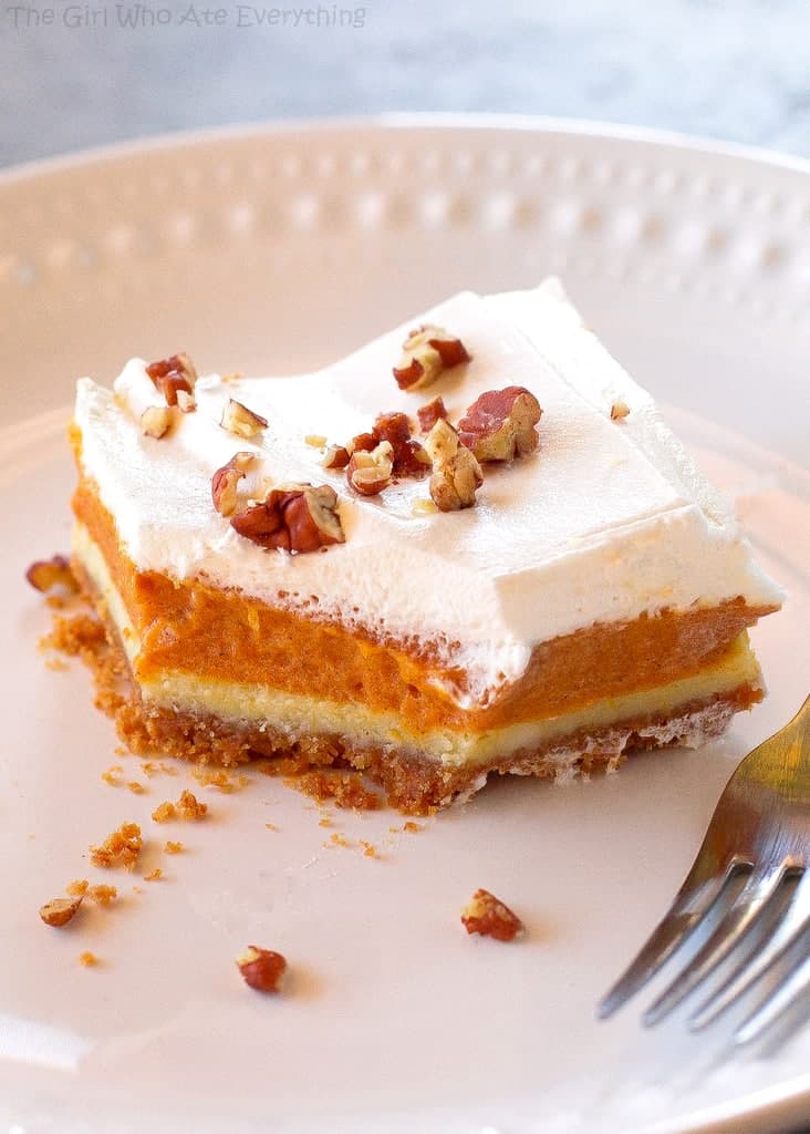 Pumpkin Pie Cheesecake Bars - A thick layer of graham cracker crust, creamy cheesecake, and spicy pumpkin pie flavored filling. the-girl-who-ate-everything.com