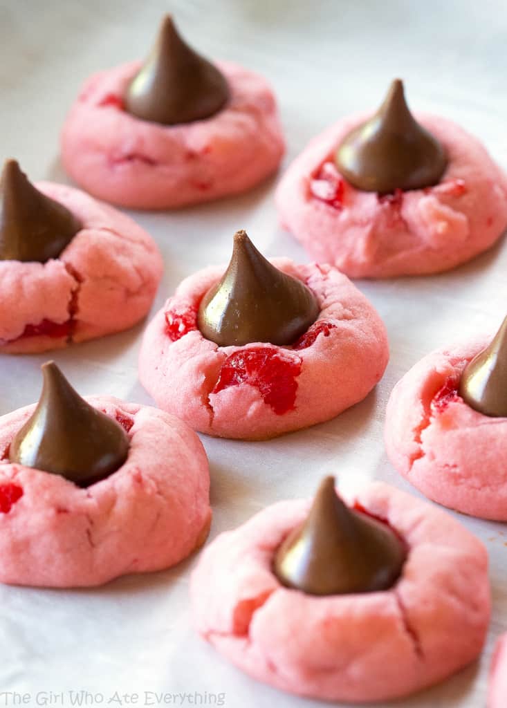 These Cherry Kiss Cookies are sweet cherry almond cookies with a chocolate Hershey kiss in the middle. Great for Christmas cookie plates.