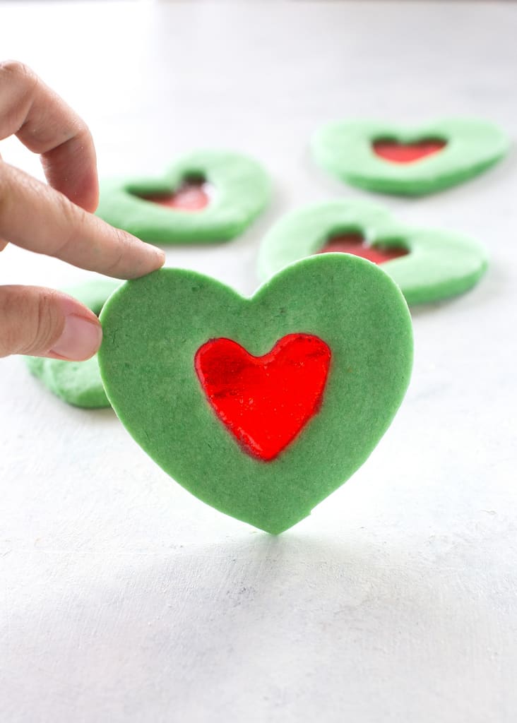 These Grinch Heart Cookies are magical little treats that you can make at Christmas with your kids. the-girl-who-ate-everything.com