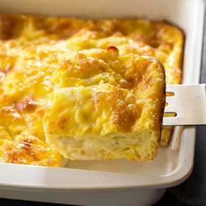 Cheesy Baked Eggs slice in a white pan