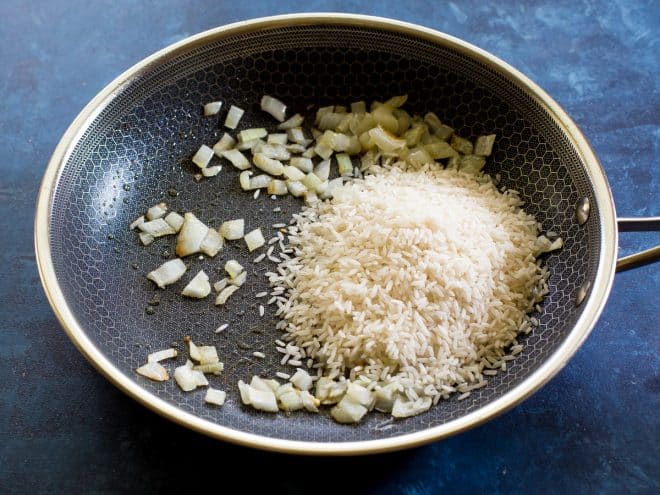 rice and onion in a skillet