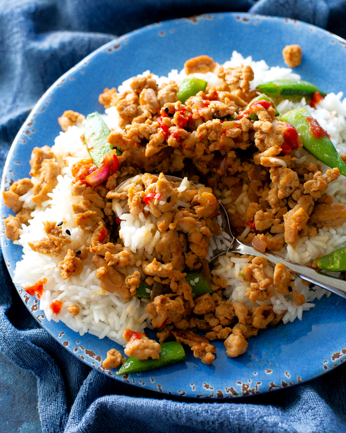 ground sesame chicken and snap peas over rice