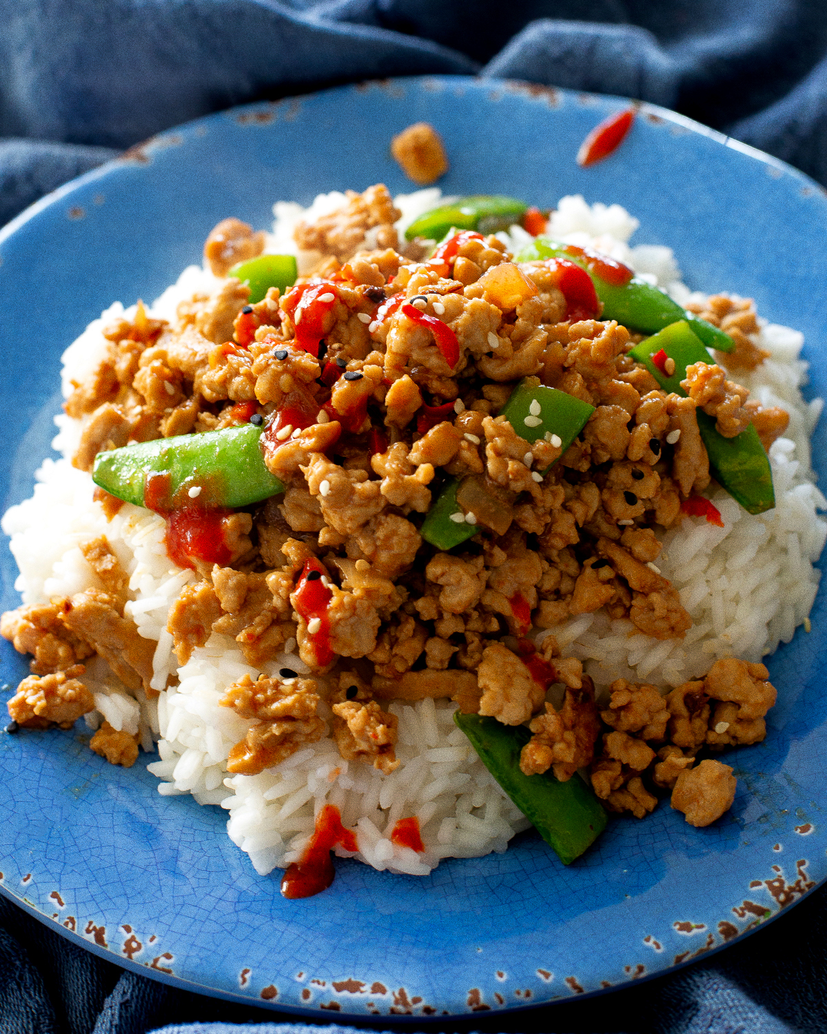 ground sesame chicken and snap peas over rice