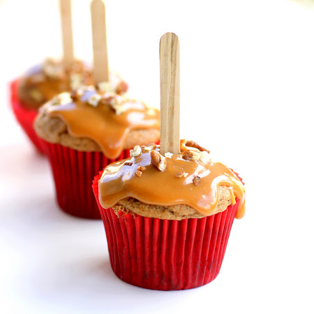 These Caramel Apple Cupcakes are simple and easy. This recipe has all of the fall flavors you love and the cupcakes are drizzled with caramel and nuts. They look like a caramel apple in cupcake form. the-girl-who-ate-everything.com