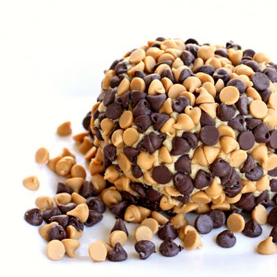 This Peanut Butter "Cheese" Ball is a creamy peanut butter mixture rolled in chocolate chips and peanut butter chips. Serve with graham crackers or apples for a sure hit! the-girl-who-ate-everything.com